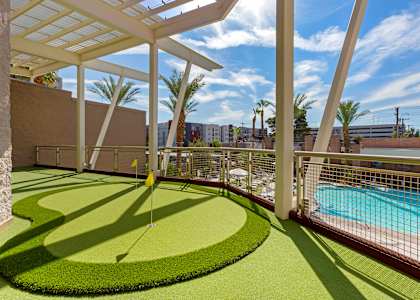 a backyard with a golf course and a pool at The Rays at Vegas Towers Apartments, Nevada, 89119