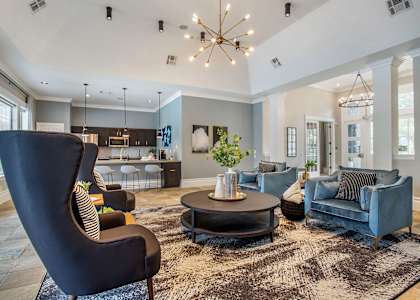 A modern living room with a black chair and a round coffee table  at Reserve by the Lake, Houston, TX, 77084