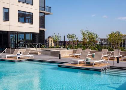 A swimming pool with sun loungers and a building in the background at 365 Nicollet, Minneapolis, MN