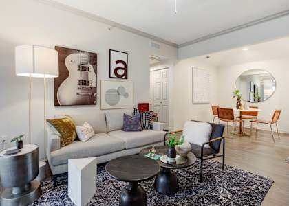 a living room with a couch and a table at The Olivine in North Austin, TX, 78727