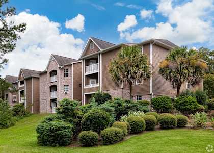 Exterior view of building with bushes at Cross Creek Apartments, Beaufort, 29906