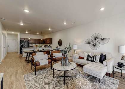 A living room with a white couch and a coffee table. at Centennial Crossing, Waukee, Iowa