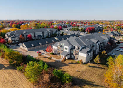 A bird's eye view of a residential area with houses and trees. at Stonegate Crossing Apartments, IOWA, 50325