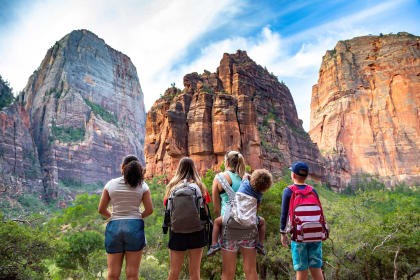 a group of girls and boys looking at rock formations