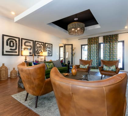 a living room with leather chairs and a table at Capstone at Banks Crossing, Commerce, 30529