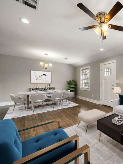 A living room with a white couch, a blue chair, and a coffee table. at Balfour Marietta Apartments, Marietta, GA, 30060