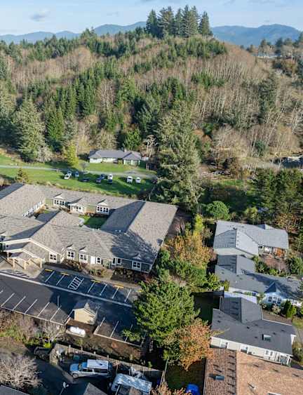 A bird's eye view of a residential area with houses and a parking lot.