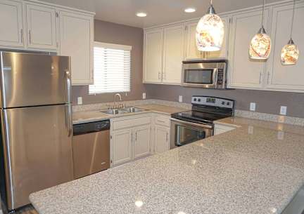 A kitchen with a granite countertop and stainless steel appliances at Sharlands Terrace Apartments, Apartments, Reno, NV
