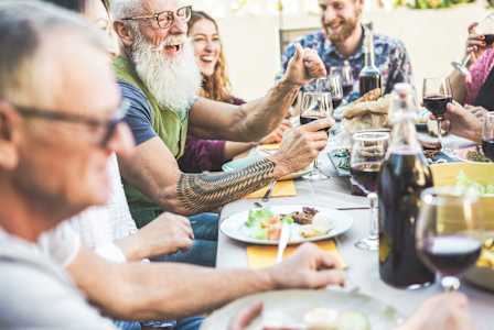 A group of people enjoying a meal and drinks together.
