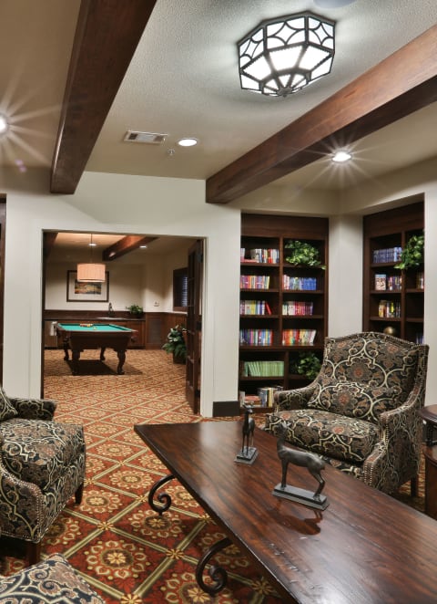 a game room with a pool table and book shelves at Mariposa at Elk Drive, Texas