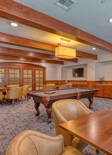a game room with a pool table and tables at Mariposa at South Broadway, Joshua Texas