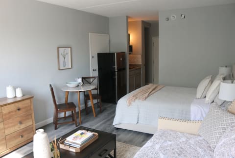 a bedroom with a bed and a couch and a table at Schaefer Ridge Apartments, Branson