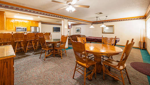 A room with a table and chairs in it.