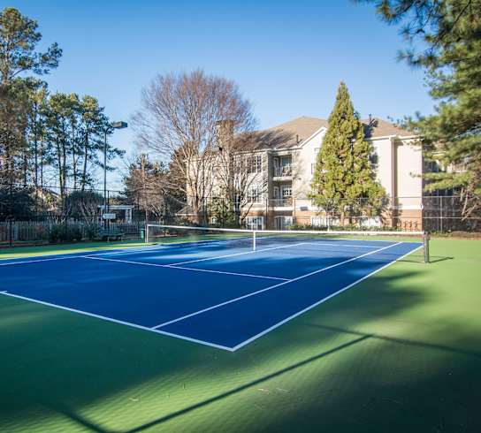 a tennis court with a house in the background at Willowest in Lindbergh in Atlanta, 30318
