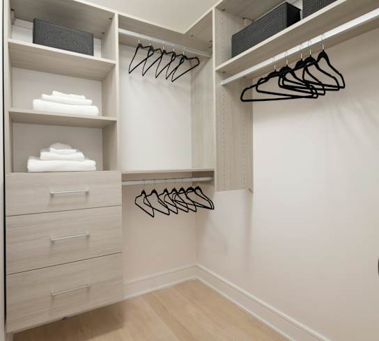 A white closet with drawers and shelves. at Chateau on Wells, Chicago, Illinois