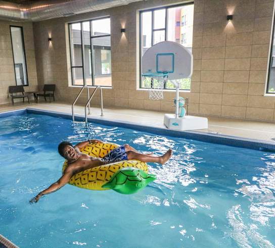 a man floating on a raft in a swimming pool at Bluestone Flats, Duluth, 55803