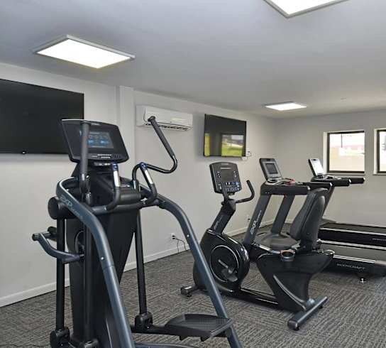 Gym with exercise bikes and a tv at Kinley Lofts, Knoxville, 37912