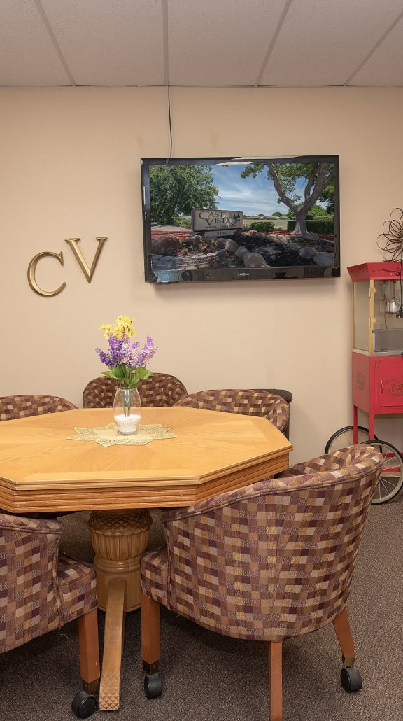 a lobby with couches and chairs and a table in the middle at Castle Vista Senior Duplex Community, Atwater, CA