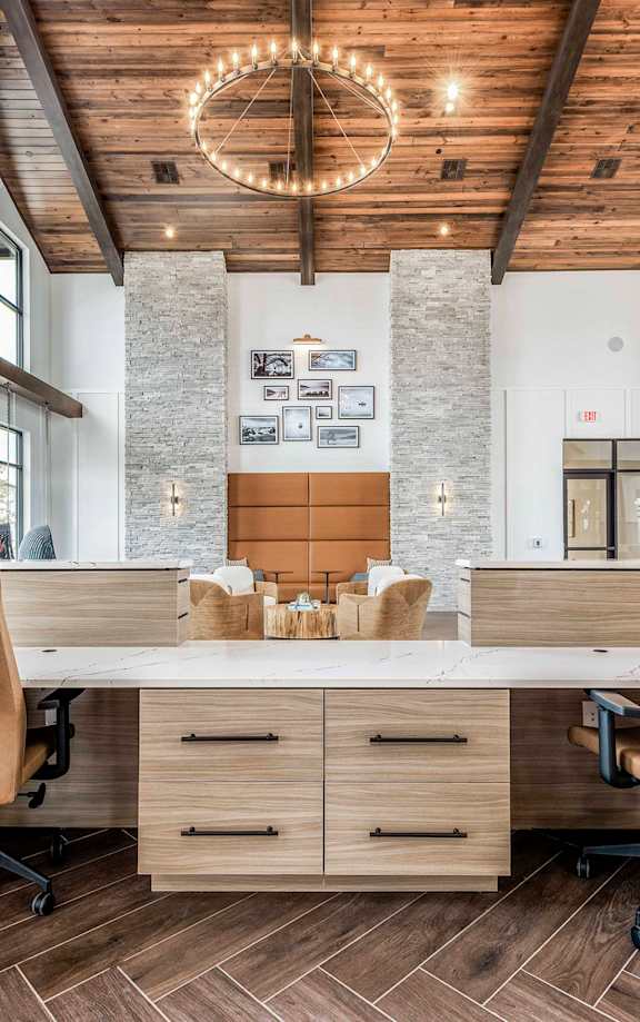 A modern interior with a pool and a bar at Stillwater Lakes Apartments, Kissimmee, Florida
