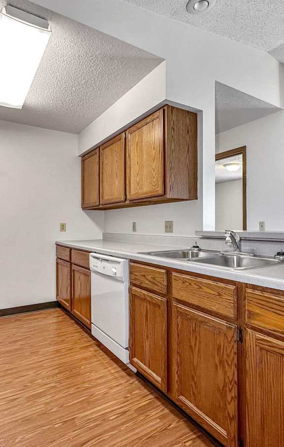 a kitchen with wooden cabinets and a sink and a refrigerator at Autumn Park, Sioux Falls, 57106