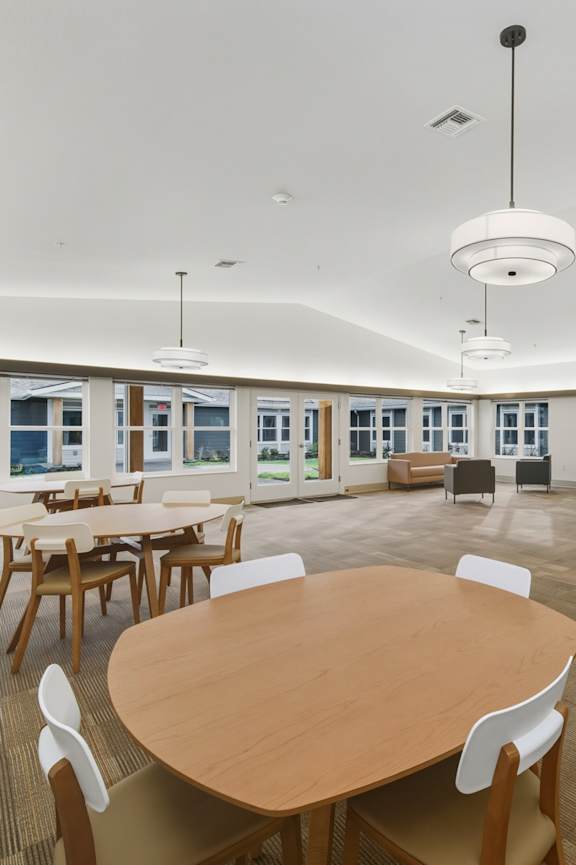 A conference room with a large table and chairs.