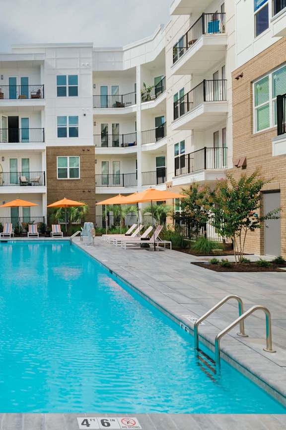 A large swimming pool in front of a building at Waterleaf at Neely Ferry Apartments, Simpsonville, SC 29680