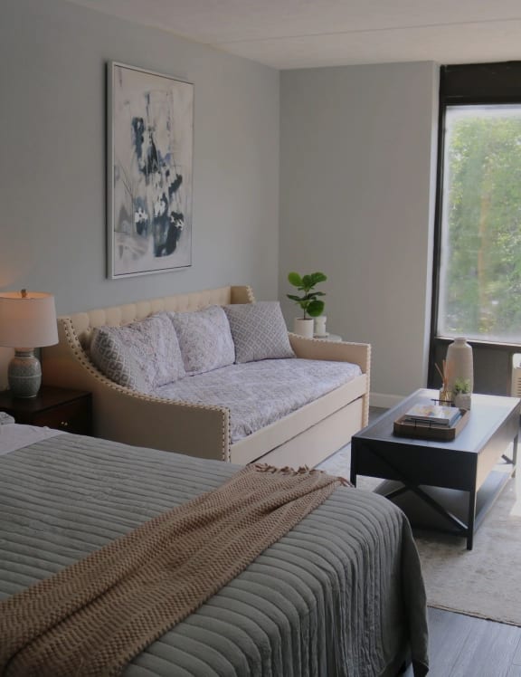 a bedroom with two beds and a couch and a table at Schaefer Ridge Apartments, Branson , MO
