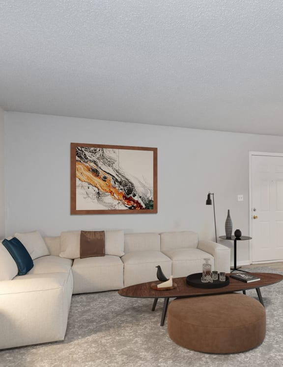 a living room with a white couch and a coffee table  at Eastwood Crossings in Kansas City, Missouri