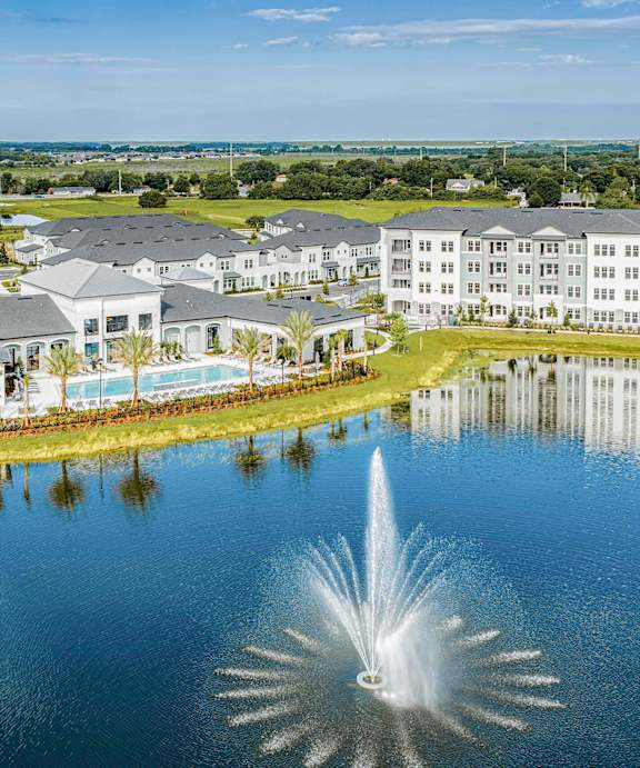 A modern interior with a pool and a bar at Stillwater Lakes Apartments, Kissimmee, FL 34744