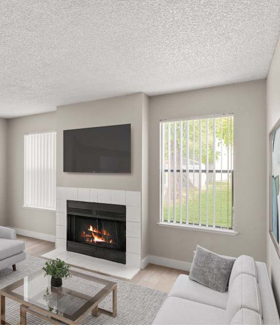 A living room with a fireplace and two chairs.