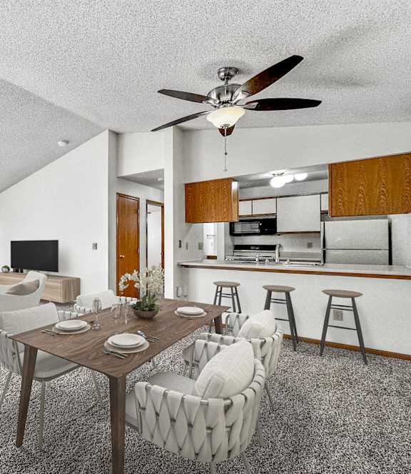A living room with a dining table and chairs. at Somerset Apartments, Des Moines, IA, 50315