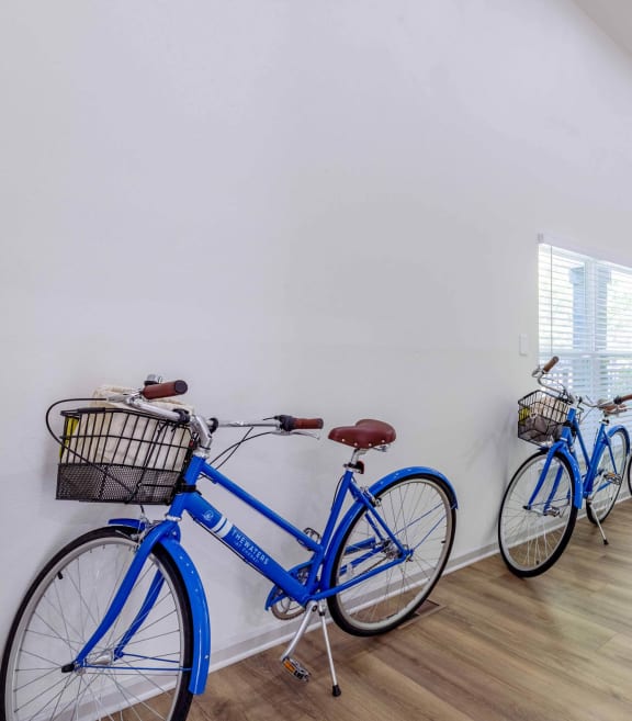 three bikes are lined up against a wall in a room with stairs at The Waters at Chenal, Little Rock, Arkansas