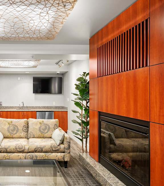 a living room with a couch and a fireplace at Celio Apartments, Portland, OR, 97205