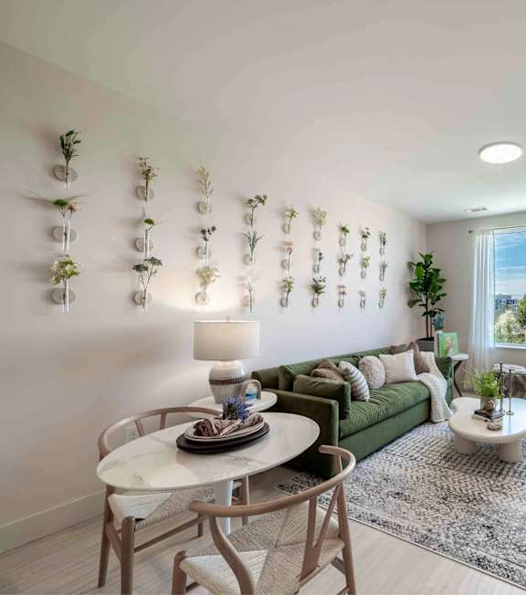 A bathroom with a toilet, sink, mirror, and wall-mounted planters.