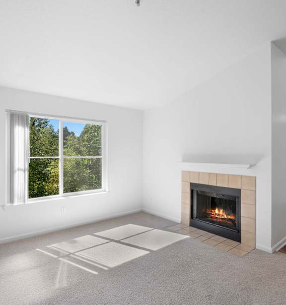 a living room with a fireplace and a window