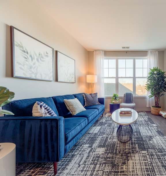 a living room with a blue couch at Heigts at Glen Mills at Heights at Glen Mills, Glen Mills, PA 19342