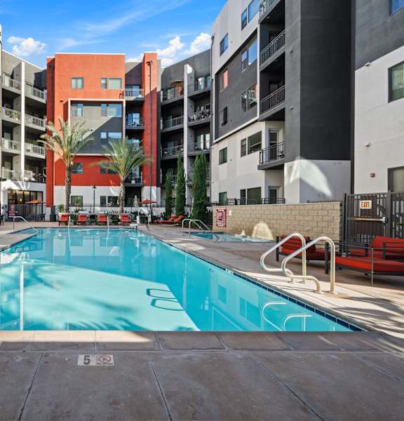 A swimming pool in a courtyard surrounded by buildings.