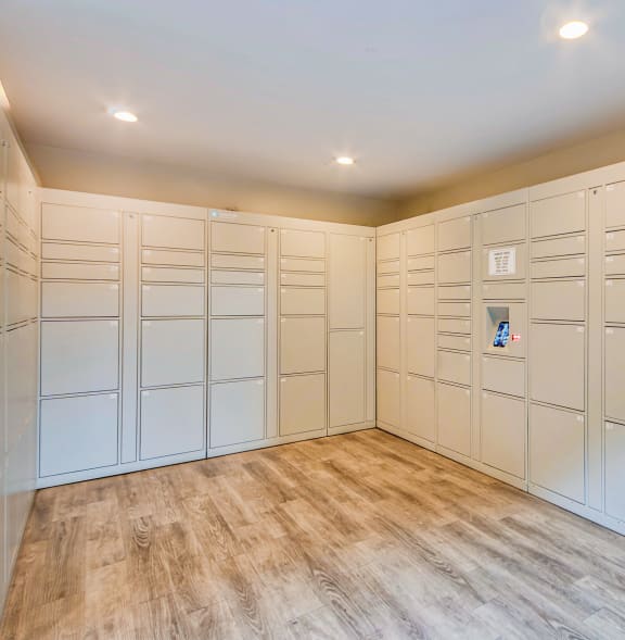 a large walk in closet with white cabinets and a wood floor at Villa Vicente, Los Angeles, CA