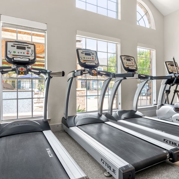 two rows of treadmills in a gym with windows at Aston at Cinco Ranch in Katy, Texas 77450