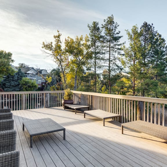 the deck has a view of the mountains and trees at Ashford Belmar Apartments, Lakewood
