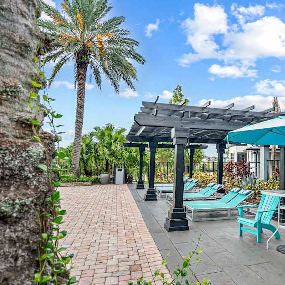 A patio with a table and chairs is surrounded by a fence.