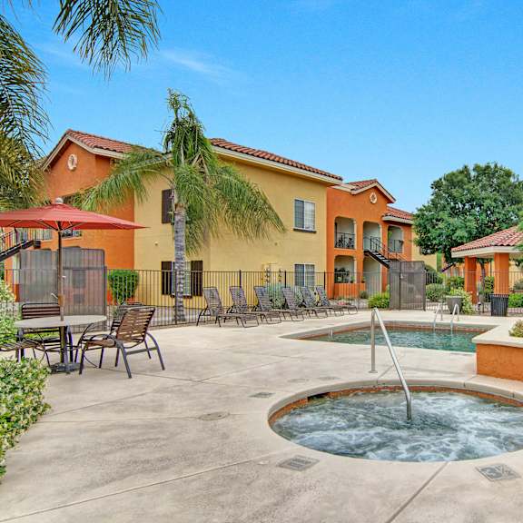 The hot tub at Retreat at Speedway, with pool tables and a table and chairs in the background. 