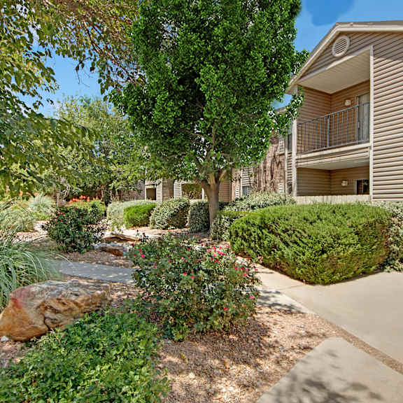 The outside of one of the apartment buildings in Northridge Court surrounded by trees. 