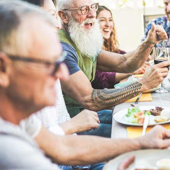 A group of people enjoying a meal and drinks together.