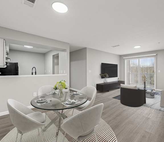 A modern living room with a glass table and white chairs.