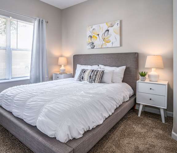 a bedroom with a large bed and a window