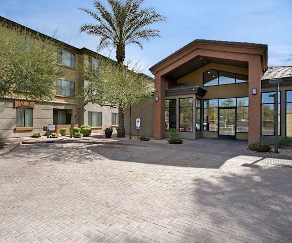 Bolero Apartments Entrance Bolero Apartments Front Entrance with long cement driveway and palm trees