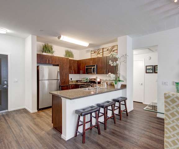 A kitchen and dining room, fully furnished, at Artisan at Main Street Mero. 