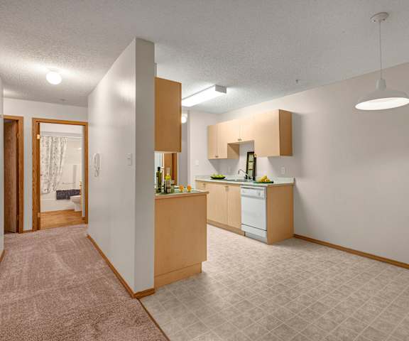 A kitchen with white appliances and counters at Edgewood Estates. 