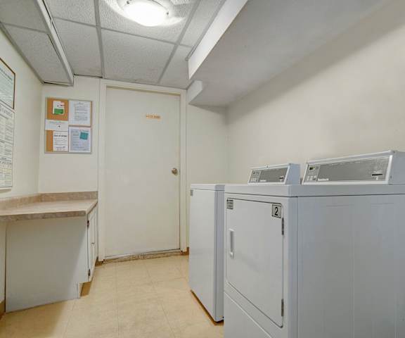 The laundry room with washers and dryers at Kingsmere. 